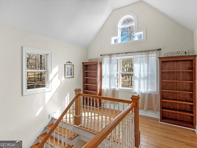 interior space featuring hardwood / wood-style flooring and high vaulted ceiling