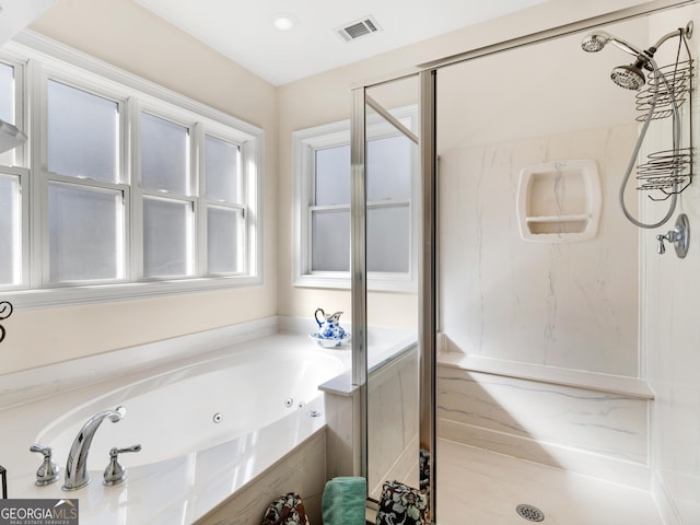 full bath featuring a tub with jets, a marble finish shower, and visible vents