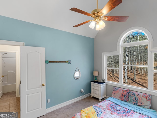 bedroom featuring lofted ceiling, light colored carpet, and ceiling fan