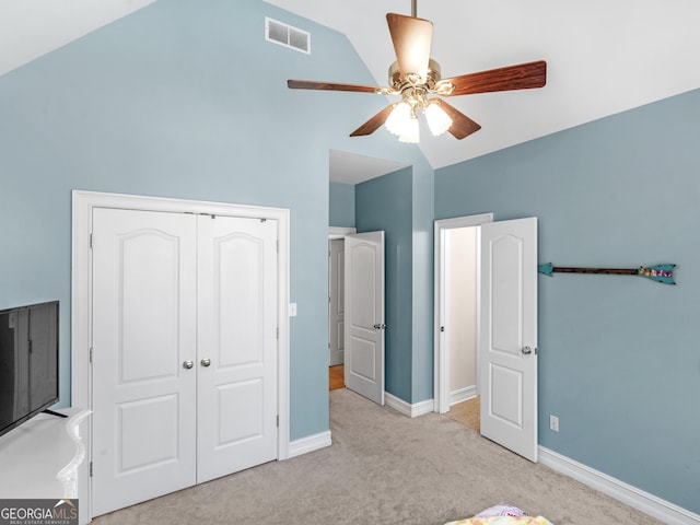 unfurnished bedroom featuring lofted ceiling, visible vents, baseboards, a closet, and carpet