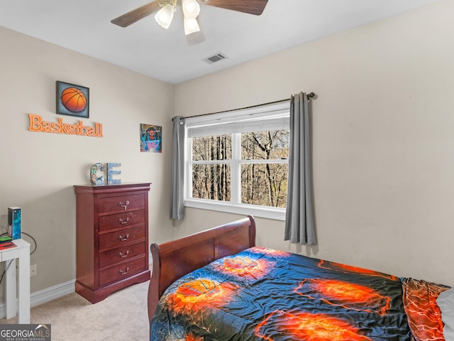 bedroom with light carpet, baseboards, visible vents, and a ceiling fan