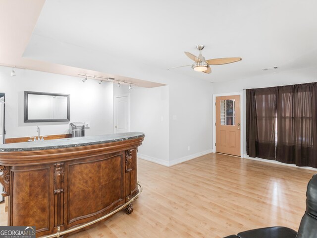 home office with ceiling fan and light wood-type flooring