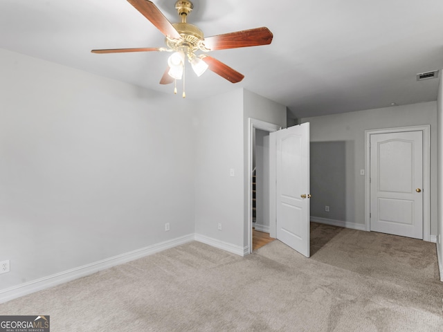 unfurnished bedroom featuring carpet floors, visible vents, baseboards, and a ceiling fan