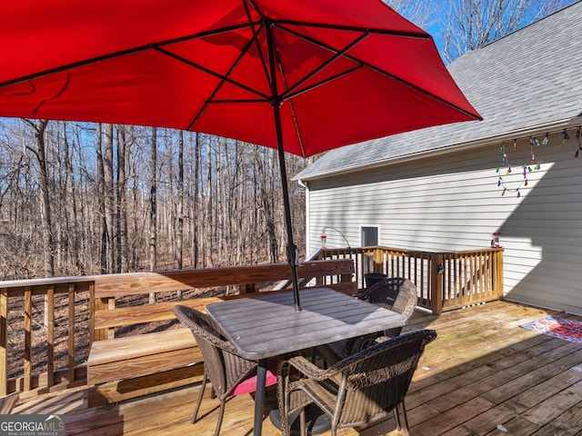 deck with outdoor dining area