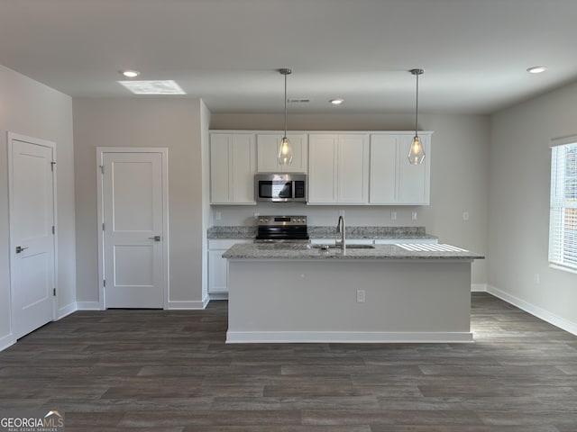 kitchen with sink, hanging light fixtures, white cabinets, and appliances with stainless steel finishes