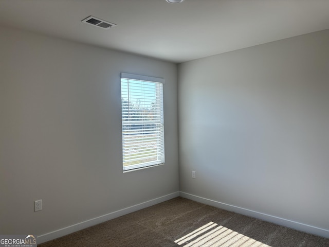 empty room featuring dark carpet