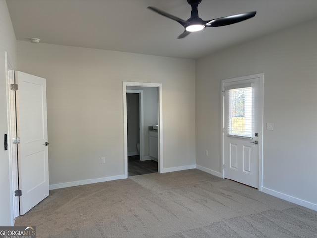 carpeted spare room with ceiling fan