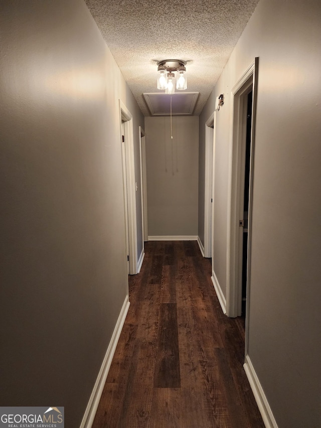 1751 Bridle Ln, Macon, GA 31220 - hallway featuring baseboards, attic access, a textured ceiling, and dark wood finished floors