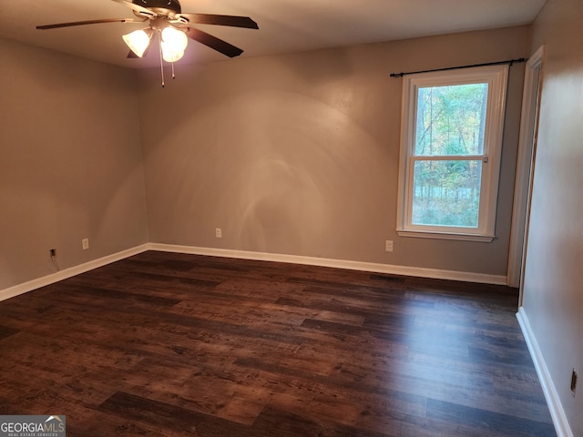 spare room with ceiling fan and dark hardwood / wood-style flooring