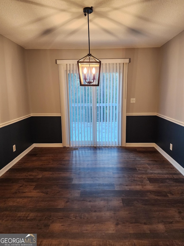 1751 Bridle Ln, Macon, GA 31220 - empty room featuring baseboards, a textured ceiling, wood finished floors, and a notable chandelier