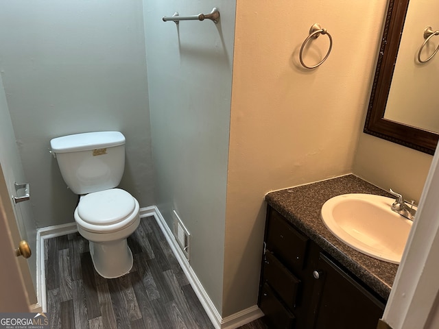 bathroom with vanity, hardwood / wood-style flooring, and toilet