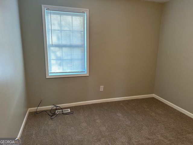 carpeted empty room featuring plenty of natural light