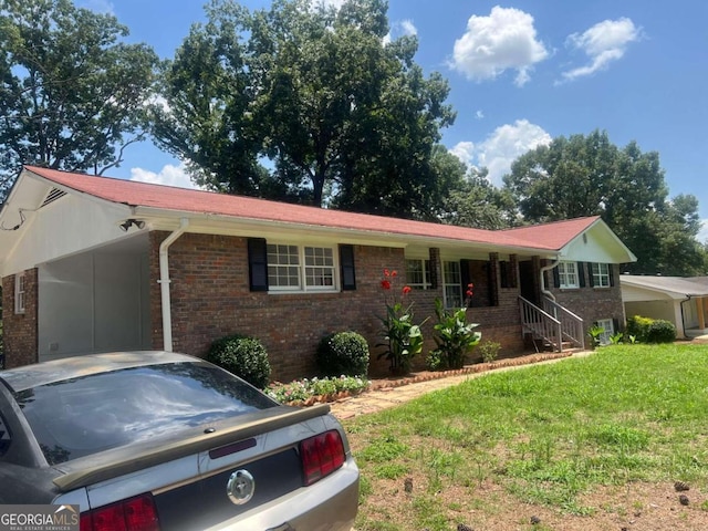 single story home featuring a carport and a front lawn