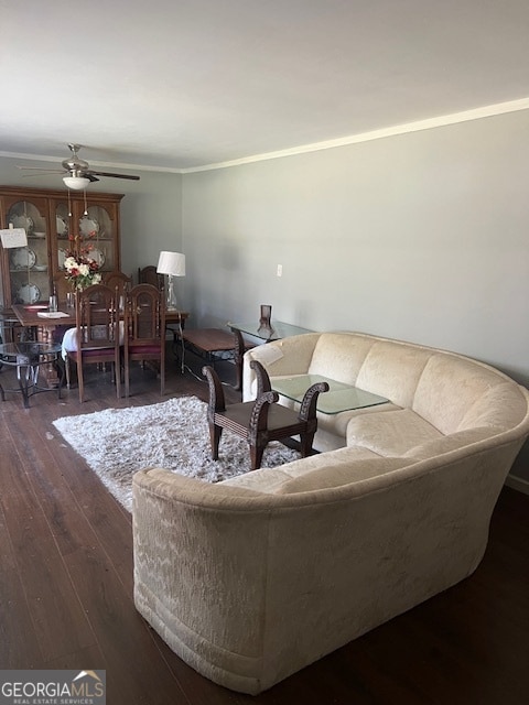 living room with ceiling fan, crown molding, and dark hardwood / wood-style floors