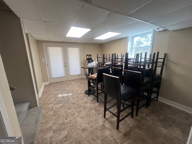 dining room featuring a paneled ceiling and french doors