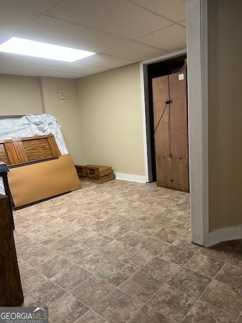 unfurnished bedroom with a paneled ceiling