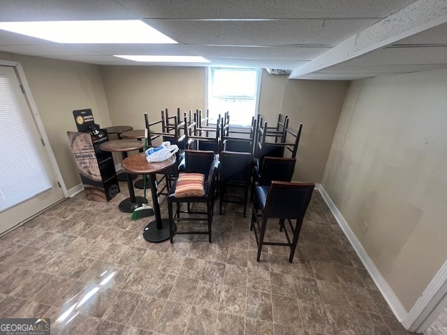 dining space with a paneled ceiling