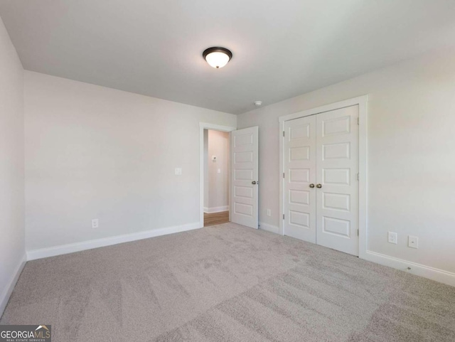 unfurnished bedroom featuring carpet floors and a closet