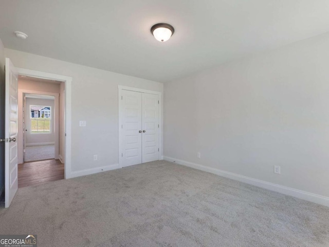 unfurnished bedroom with carpet and a closet