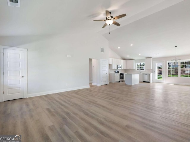 unfurnished living room featuring ceiling fan, light hardwood / wood-style floors, and high vaulted ceiling