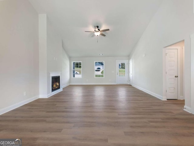 unfurnished living room featuring ceiling fan and hardwood / wood-style flooring