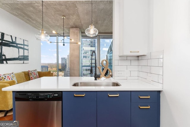 kitchen featuring dishwasher, sink, decorative backsplash, hanging light fixtures, and blue cabinetry