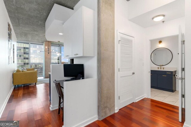 corridor with hardwood / wood-style flooring and expansive windows