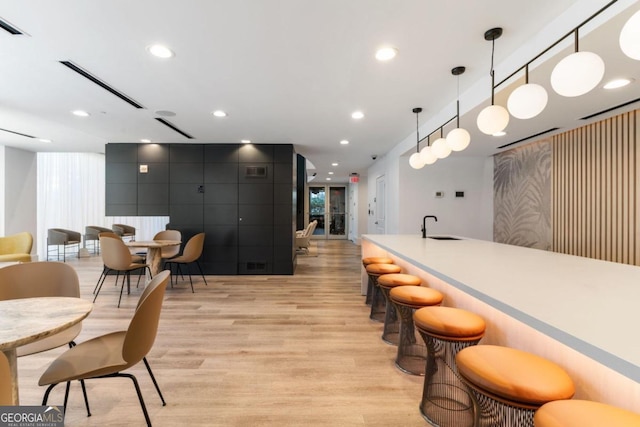 interior space with light hardwood / wood-style flooring and wet bar