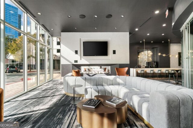 living room featuring expansive windows and an inviting chandelier