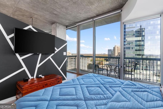 bedroom featuring expansive windows and access to outside