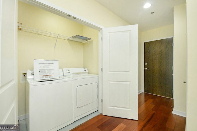 laundry room featuring washer and dryer and dark hardwood / wood-style floors