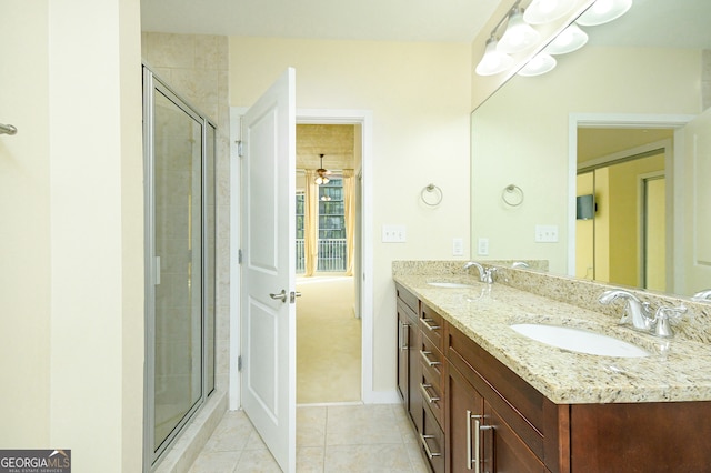 bathroom with tile patterned flooring, vanity, a shower with door, and ceiling fan