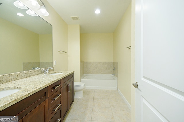 bathroom with tile patterned flooring, vanity, toilet, and a bathing tub