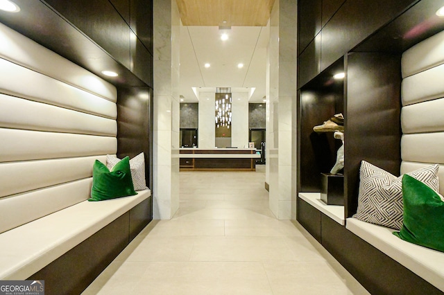 hall featuring light tile patterned floors