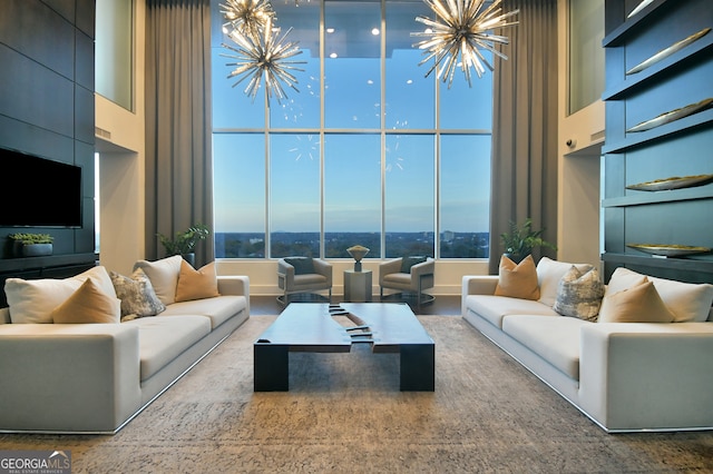 living room with a towering ceiling and an inviting chandelier