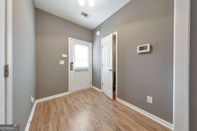 entrance foyer with light hardwood / wood-style flooring and vaulted ceiling