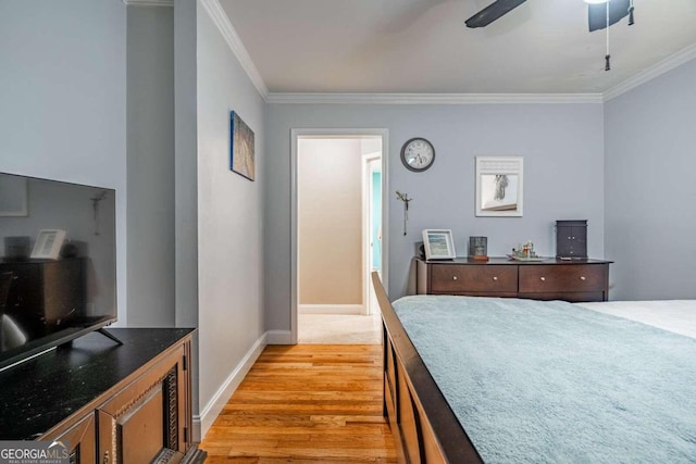 bedroom with ceiling fan, crown molding, and light hardwood / wood-style floors