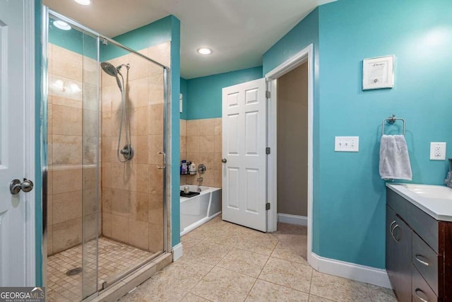 bathroom with tile patterned floors, vanity, and independent shower and bath