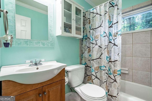 full bathroom with vanity, shower / bath combination with curtain, toilet, and ornamental molding