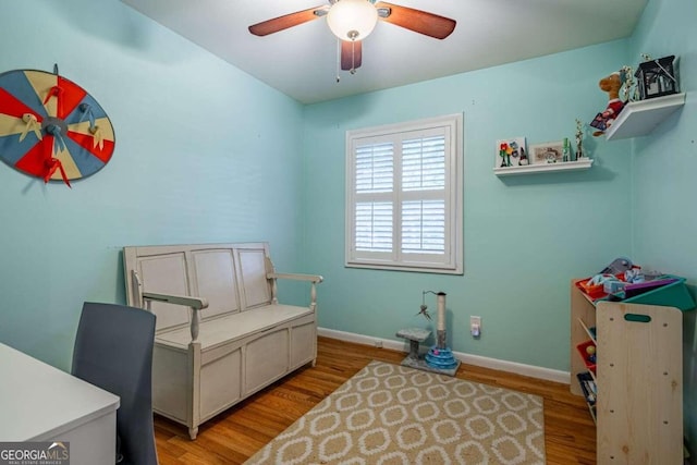 sitting room with light hardwood / wood-style floors and ceiling fan