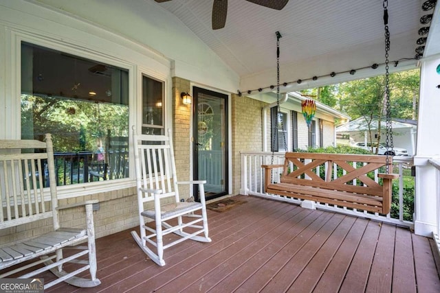 wooden terrace featuring ceiling fan and covered porch