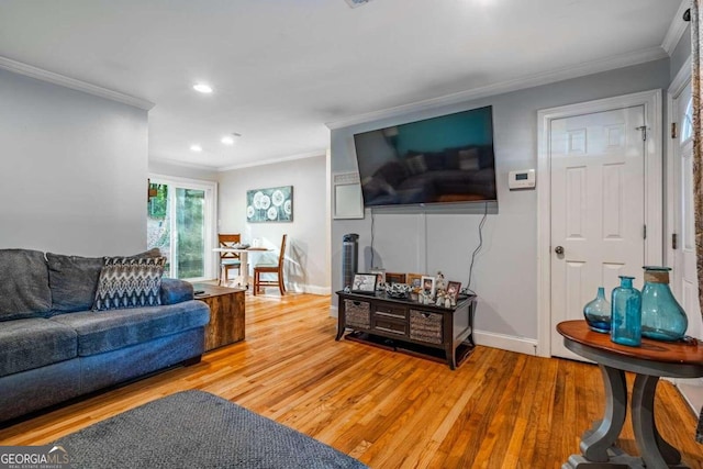 living room with hardwood / wood-style floors and crown molding