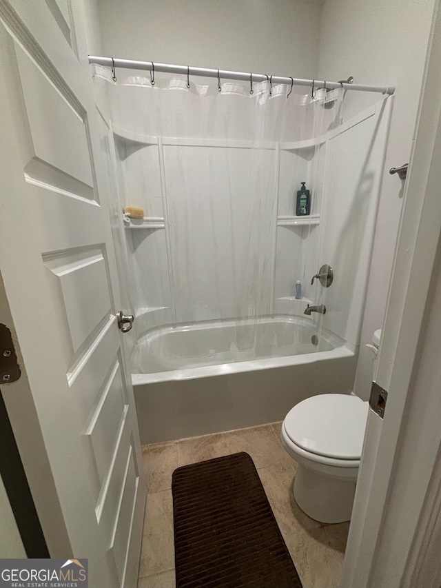 bathroom featuring tile patterned flooring, toilet, and shower / bath combo with shower curtain