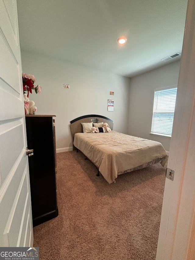 bedroom featuring dark colored carpet