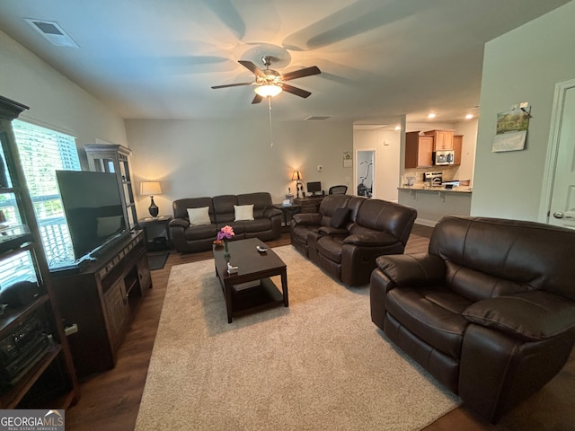 living room featuring ceiling fan and hardwood / wood-style flooring