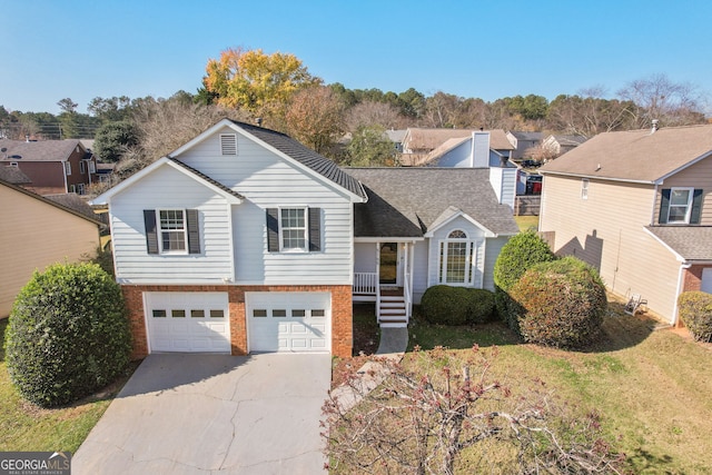 view of front of property with a garage and a front lawn