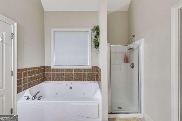 bathroom with shower with separate bathtub