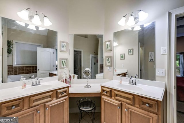 bathroom with a bath, vanity, and an inviting chandelier