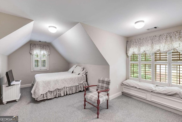 carpeted bedroom featuring vaulted ceiling and radiator