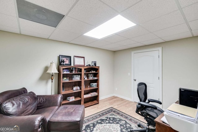 office with a paneled ceiling and light hardwood / wood-style floors